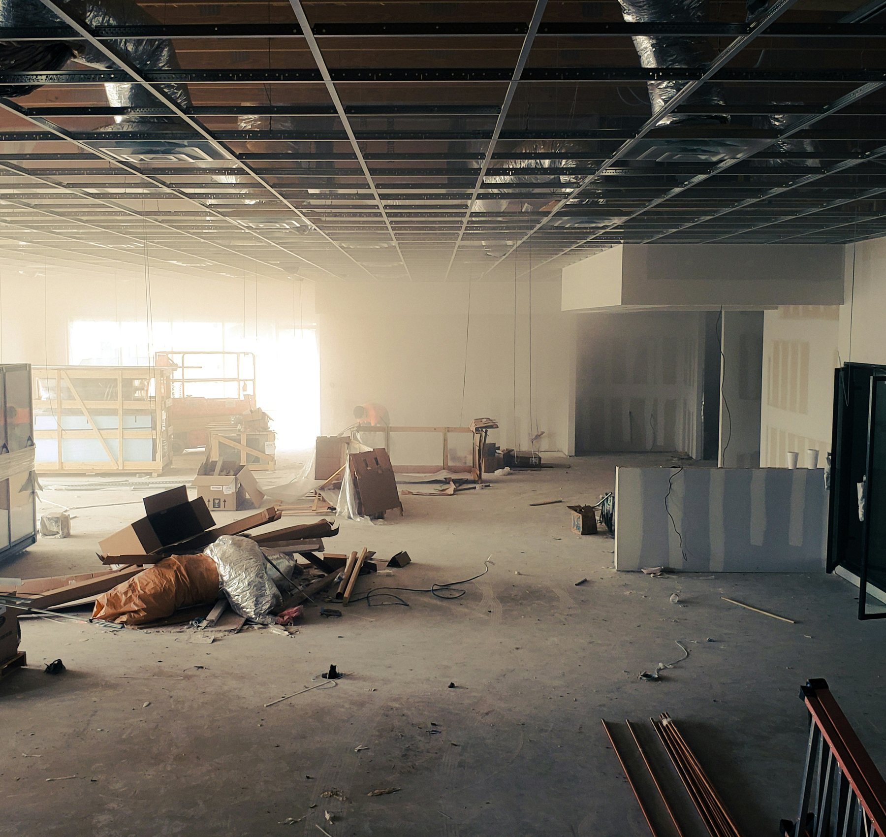 Commercial space under construction with ceiling grid installed