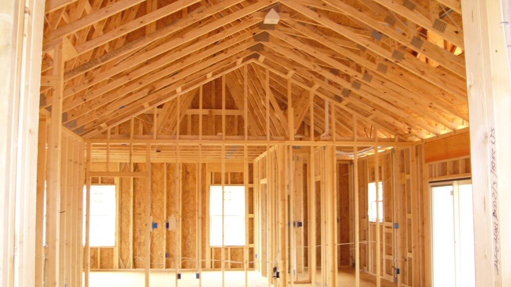 Crew member framing a wall on a residential job site