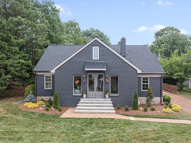Charcoal painted-brick front elevation with French-door entry